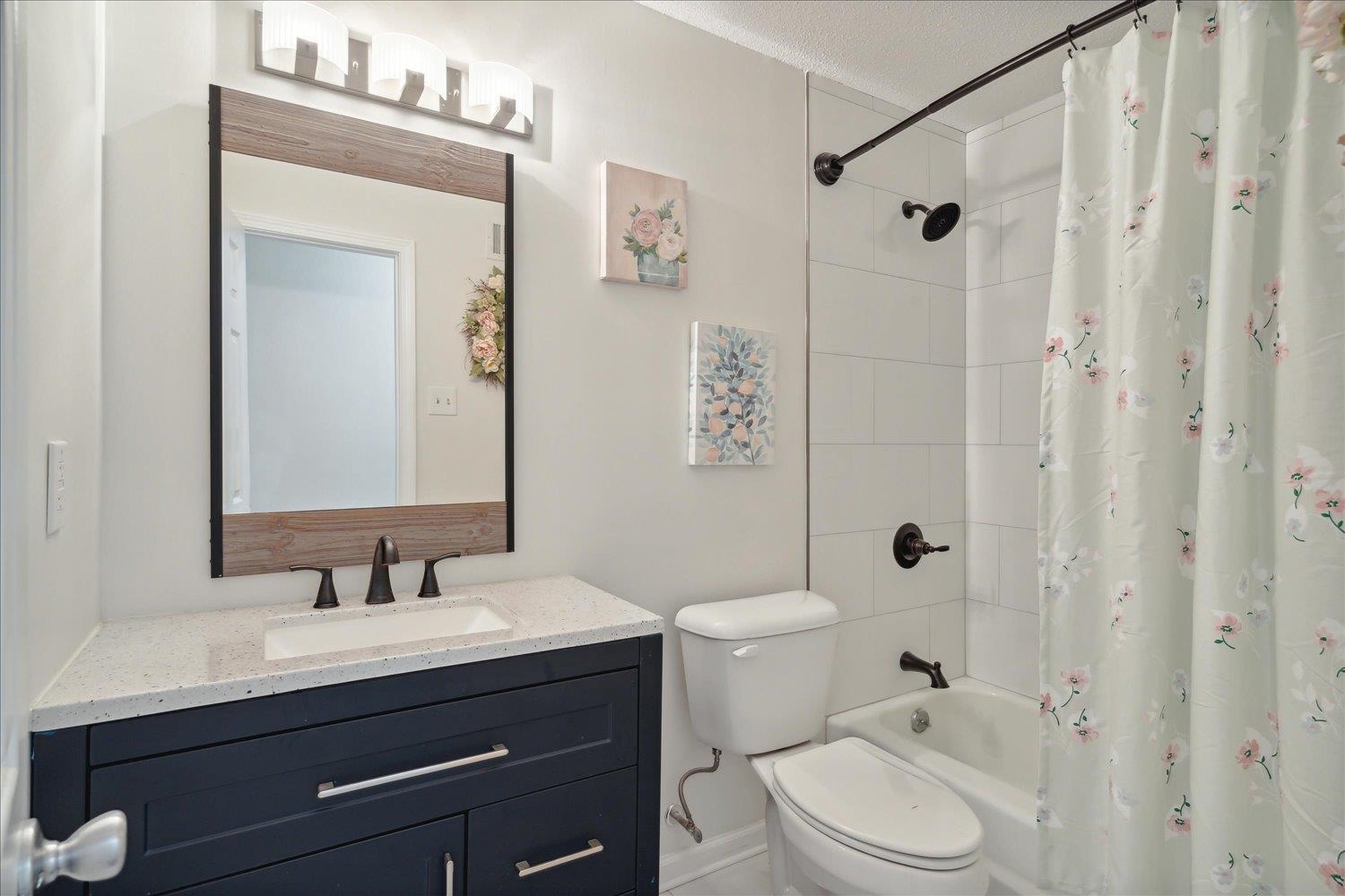 3093 Altruria Road Bartlett, TN 38134 - Photo 21 of 26 a bathroom with a sink a toilet and shower