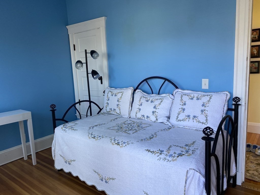 72 Everett Street Arlington, MA 02474 - Photo 15 of 25 a bed sitting in a bedroom next to a window