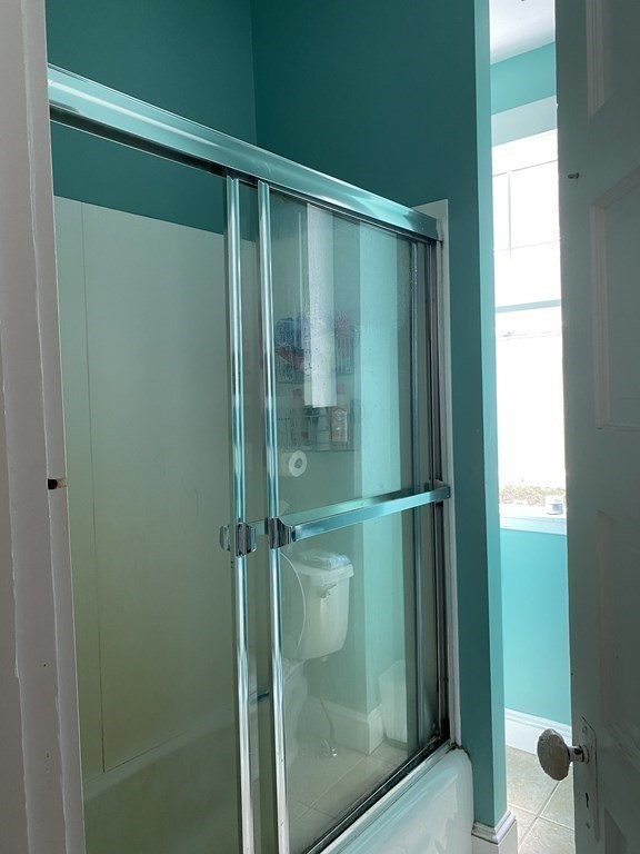 72 Everett Street Arlington, MA 02474 - Photo 23 of 25 a bathroom with a glass shower door