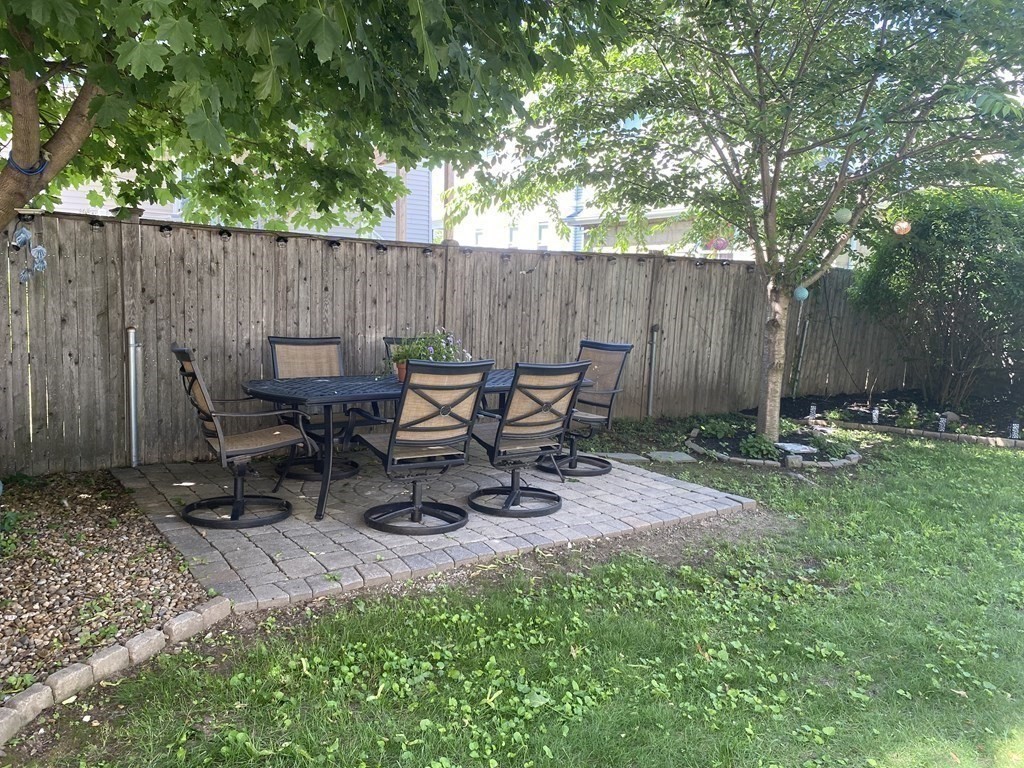 72 Everett Street Arlington, MA 02474 - Photo 4 of 25 a view of a chairs and table in backyard