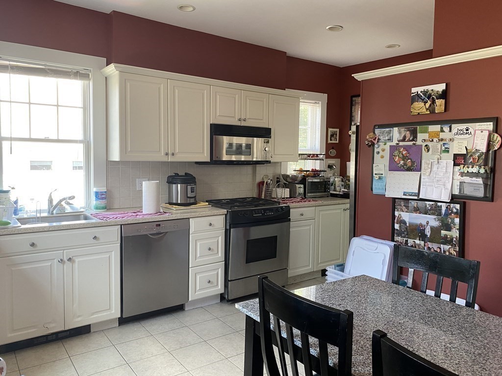 72 Everett Street Arlington, MA 02474 - Photo 8 of 25 a kitchen with a stove a sink and a refrigerator