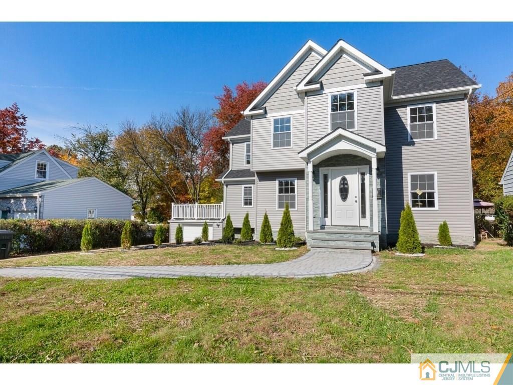 80 Lancaster Road Colonia, NJ 07067 - Photo 1 of 15 a front view of a house with a yard