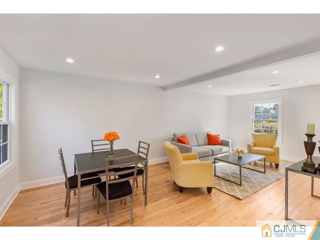 80 Lancaster Road Colonia, NJ 07067 - Photo 6 of 15 a living room with a couch and a table with wooden floor