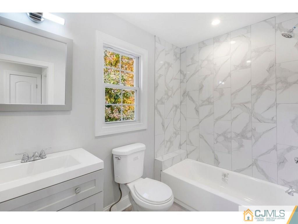 80 Lancaster Road Colonia, NJ 07067 - Photo 10 of 15 a bathroom with a sink a toilet and tub