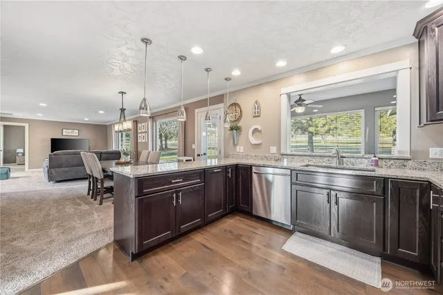 a large kitchen with stainless steel appliances granite countertop a sink and a stove