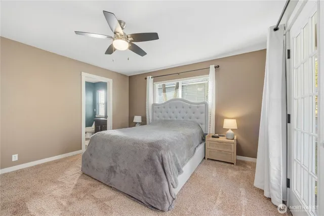 a bedroom with a large bed and a ceiling fan