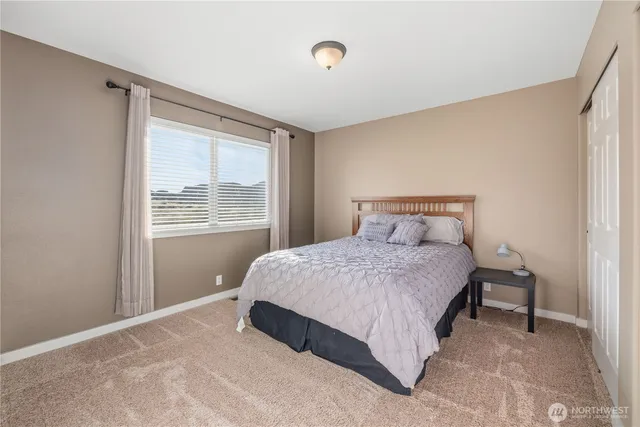 a bedroom with a bed and window