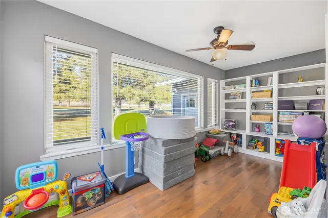 a living room filled with furniture and a bookshelf