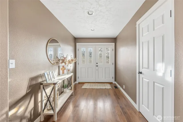 a view of a hallway view with wooden floor and staircase