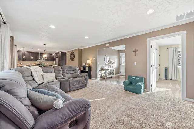a living room with furniture and a view of bathroom