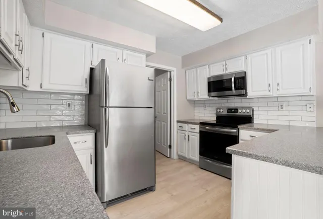a kitchen with a refrigerator stove and microwave