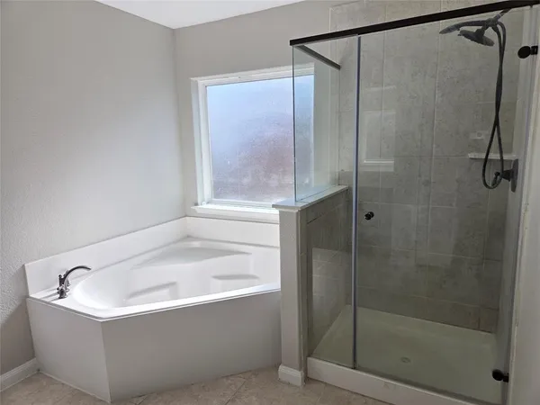 a white bath tub sitting next to a shower