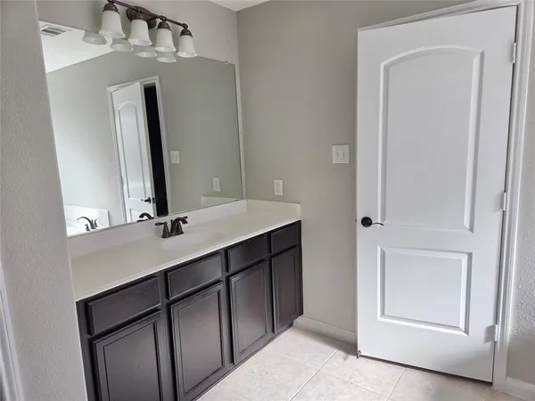 a bathroom with a sink vanity and mirror