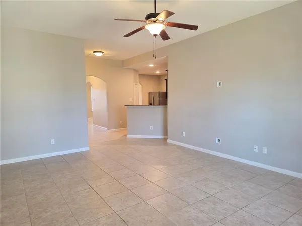 an empty room with fan and a ceiling fan