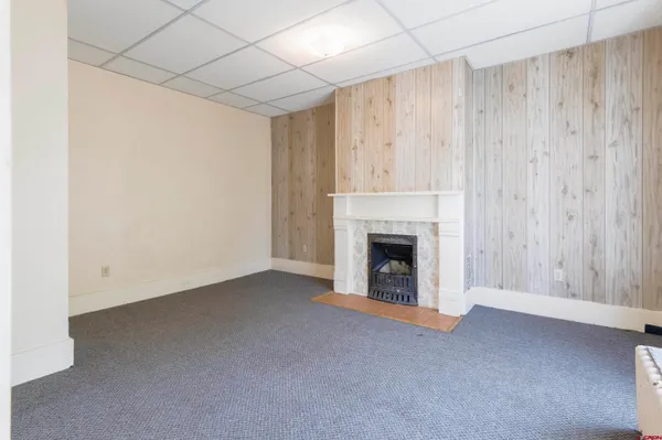a view of empty room with a fireplace and cabinet