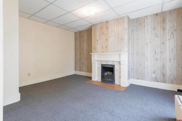 a view of empty room with a fireplace and cabinet