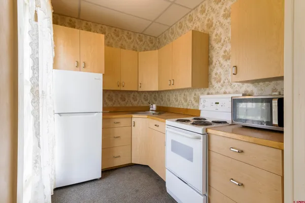 a kitchen with a stove a sink and a refrigerator