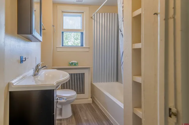 a bathroom with a sink toilet and shower