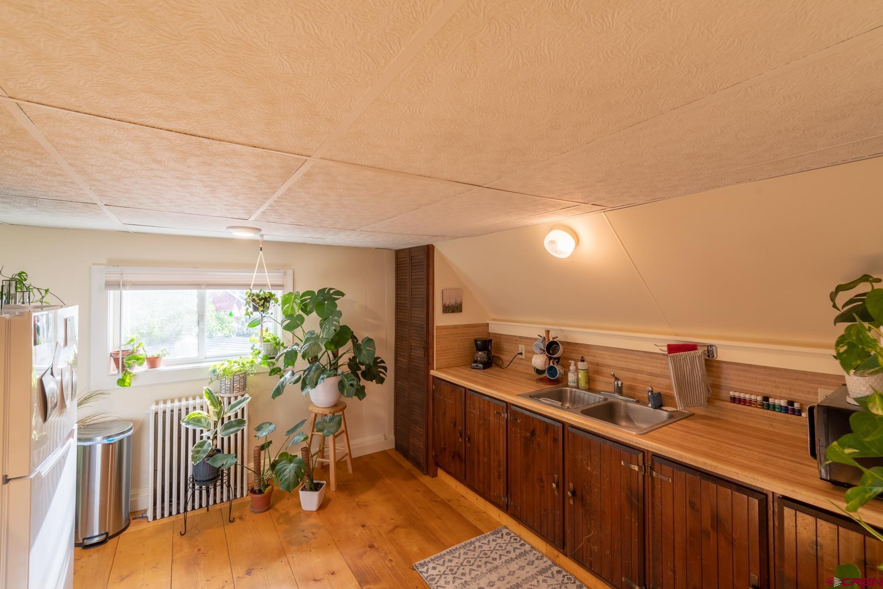 518 East Georgia Avenue Gunnison, CO 81230 - Photo 28 of 40 a living room with furniture a chandelier and a dining table