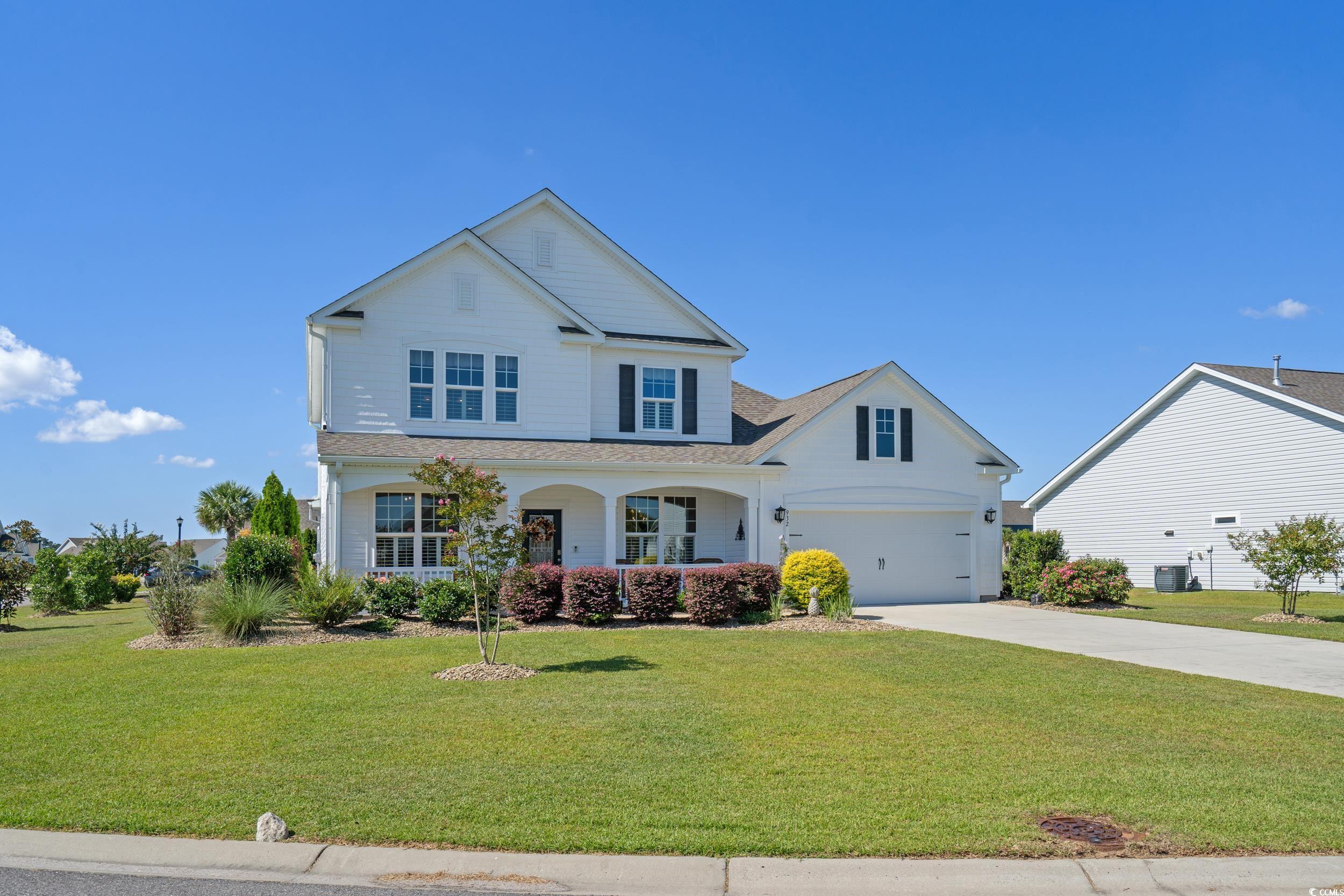 932 Abernathy Place Surfside Beach, SC 29575 - Photo 1 of 40 View of front facade featuring driveway, a front yard, a porch, and roof with shingles