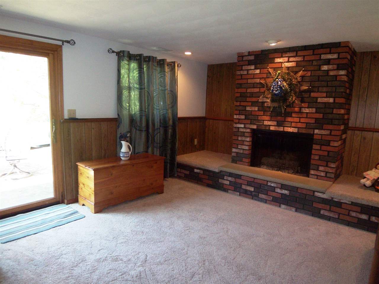 2666 South Rock City Road Ridott, IL 61067 - Photo 14 of 25 a living room with furniture a fireplace and a flat screen tv