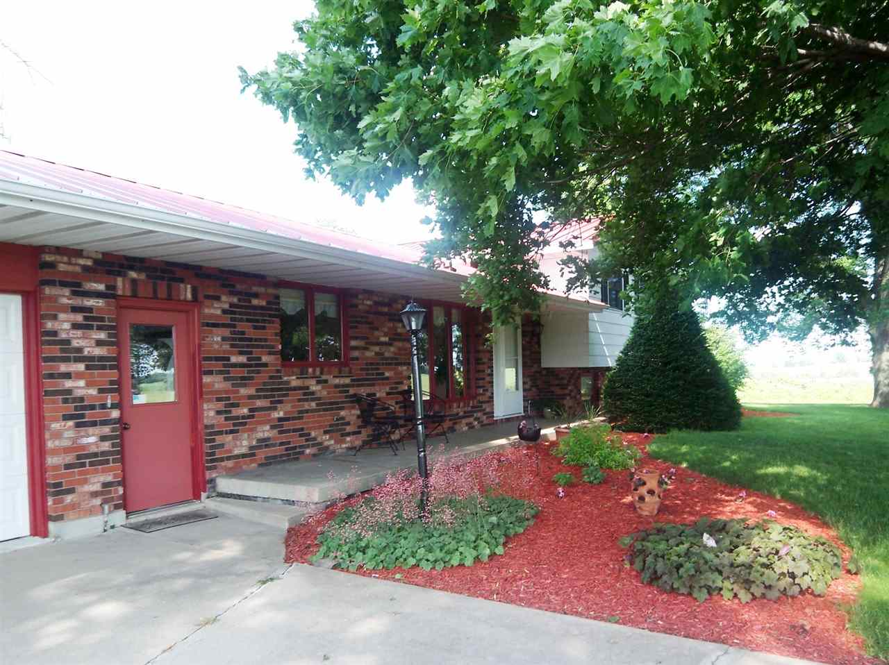 2666 South Rock City Road Ridott, IL 61067 - Photo 2 of 25 a front view of a house with garden