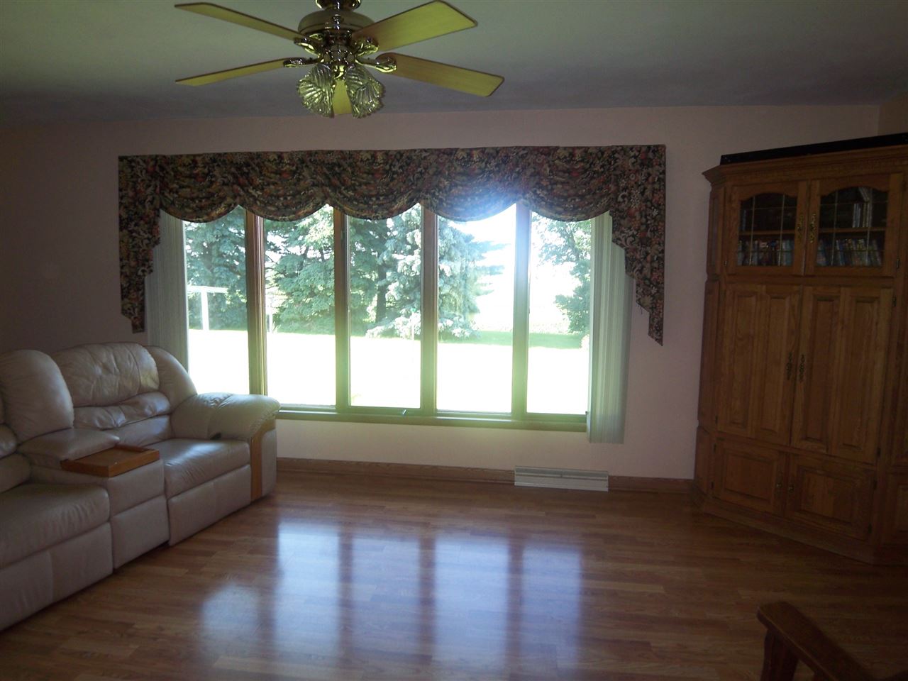 2666 South Rock City Road Ridott, IL 61067 - Photo 5 of 25 a living room with couches and a dining table with wooden floor