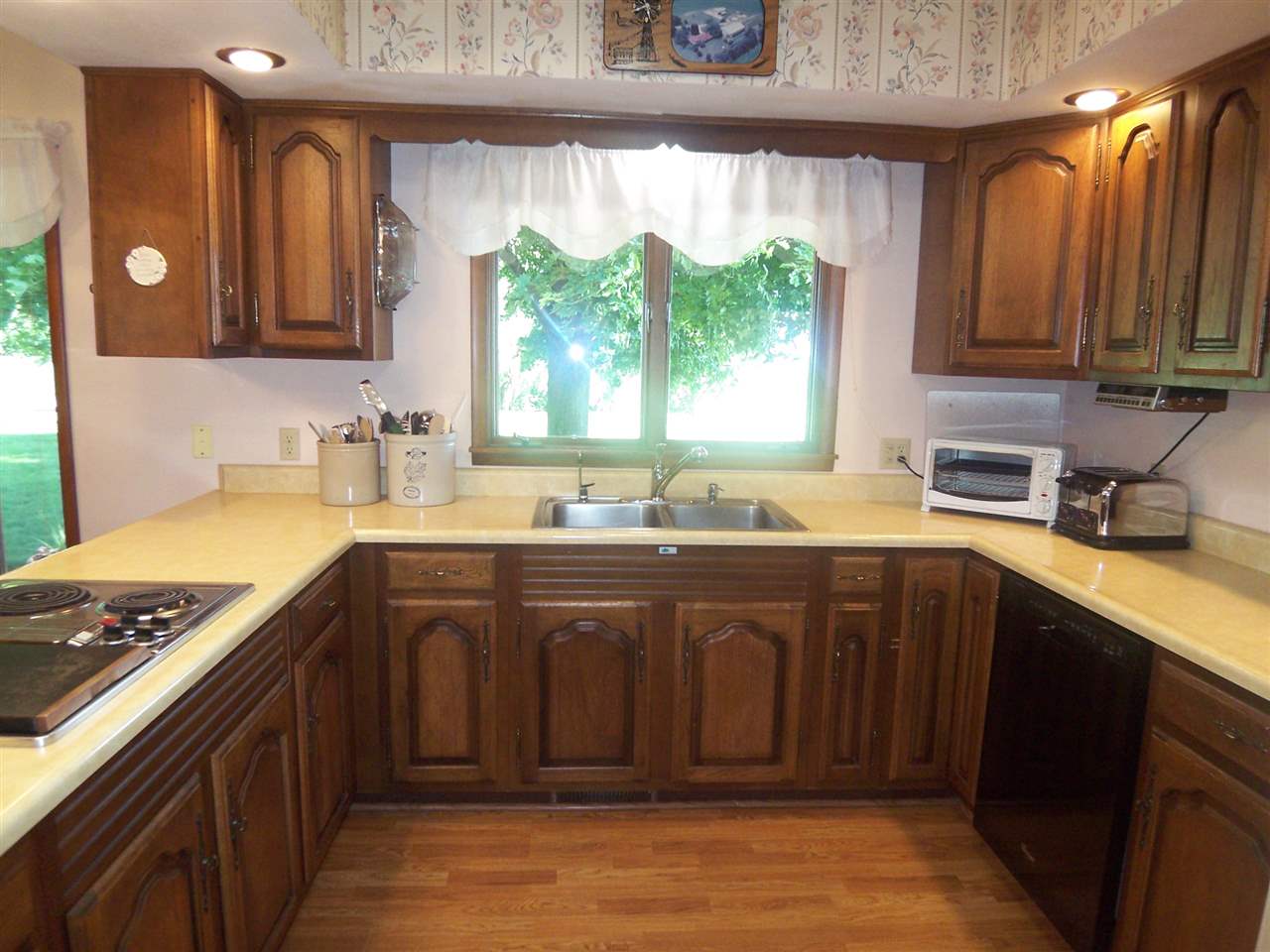 2666 South Rock City Road Ridott, IL 61067 - Photo 7 of 25 a kitchen with stainless steel appliances wooden cabinets a sink and a stove