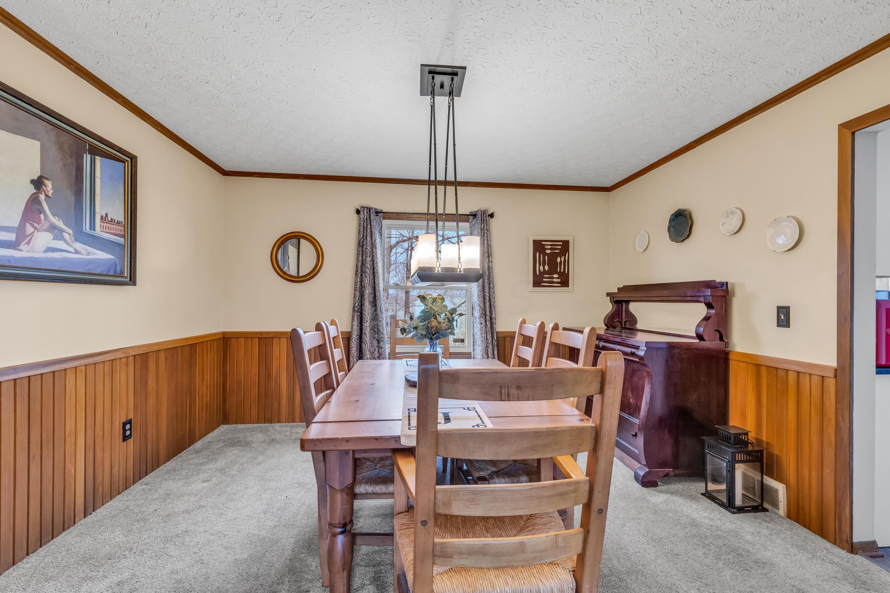 435 Emory Street Gahanna, OH 43230 - Photo 13 of 54 • New light sand
carpet ~ 2022
• Vanilla painted & half
wainscoted walls
• Crown molding
• Chair railing
• New chandelier ~ 2020
• Drapes remain