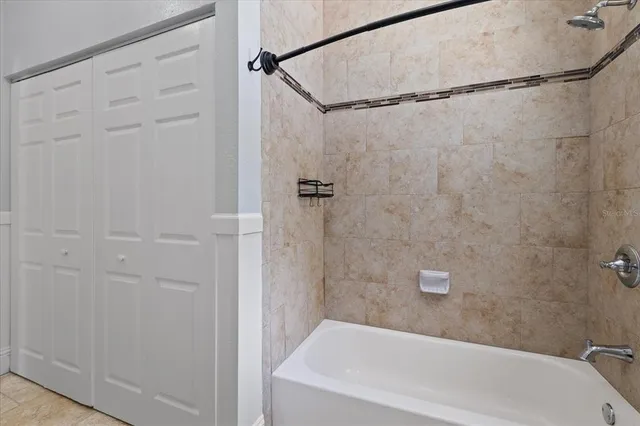 a bathroom with a shower and a bath tub