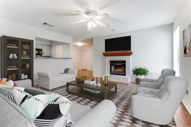 a living room with furniture a flat screen tv and a fireplace