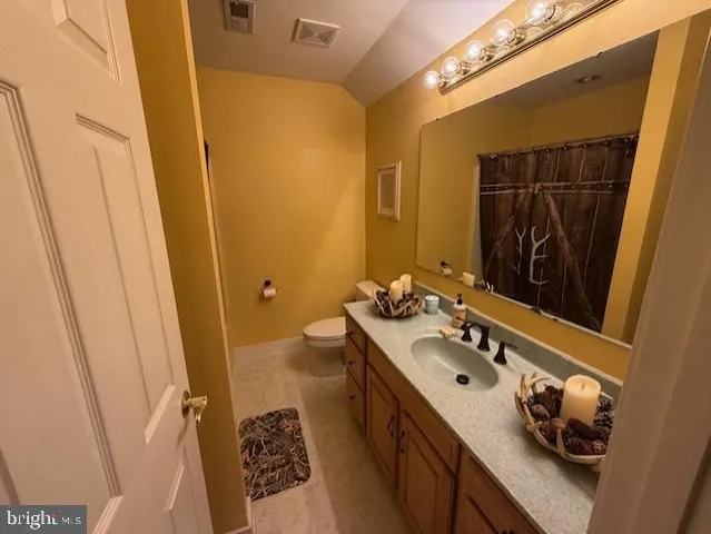 a spacious bathroom with a double vanity sink and mirror
