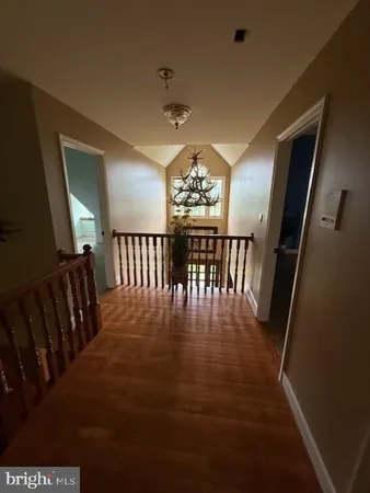 a view of a dining room with furniture wooden floor and chandelier