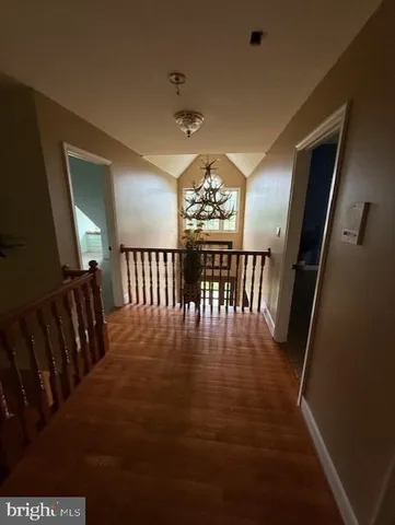 a view of a dining room with furniture wooden floor and chandelier