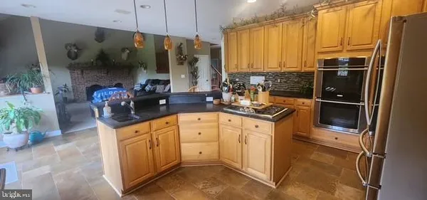a kitchen with granite countertop a sink stove and cabinets