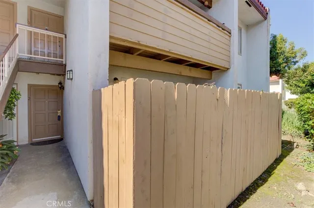 a view of a house with a door and wooden walls