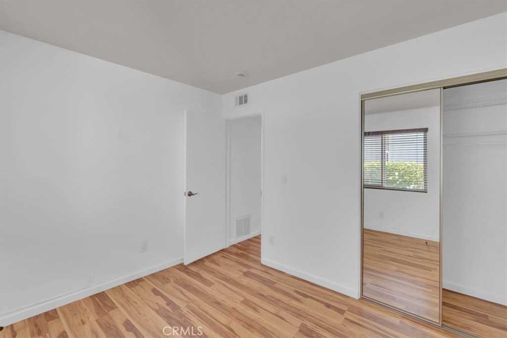 2521 West Sunflower Avenue, Unit H2 Santa Ana, CA 92704 - Photo 12 of 30 a view of an empty room with wooden floor