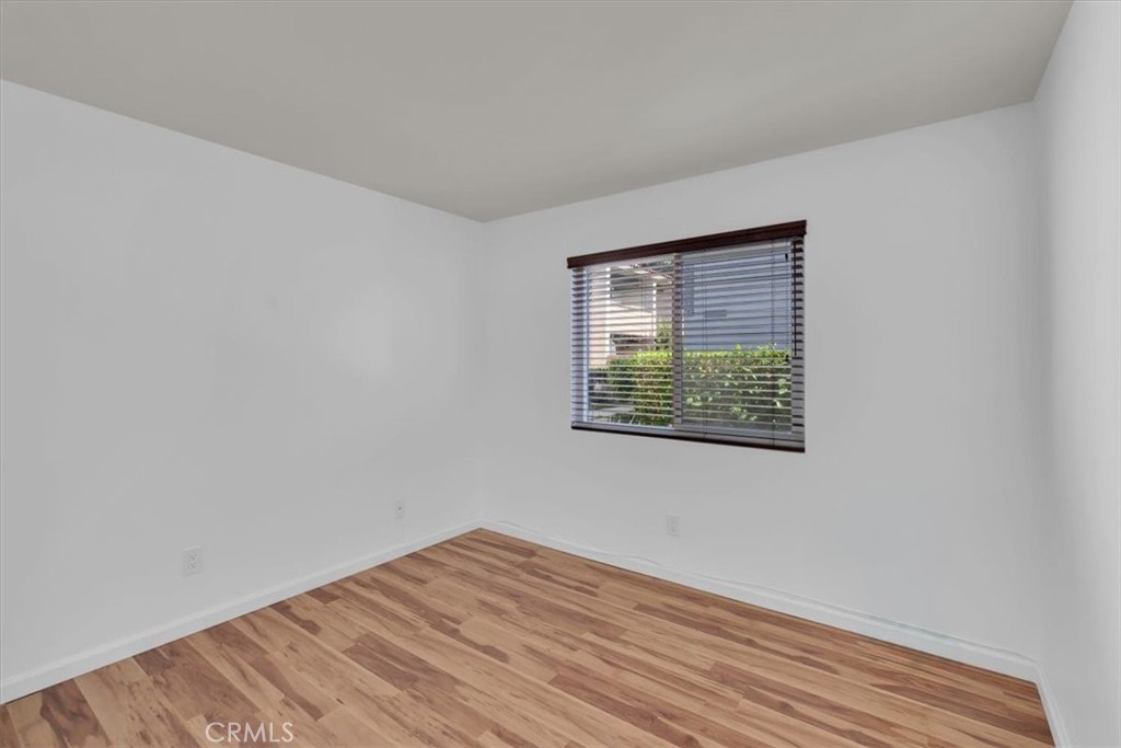 2521 West Sunflower Avenue, Unit H2 Santa Ana, CA 92704 - Photo 13 of 30 a view of an empty room with wooden floor and a window