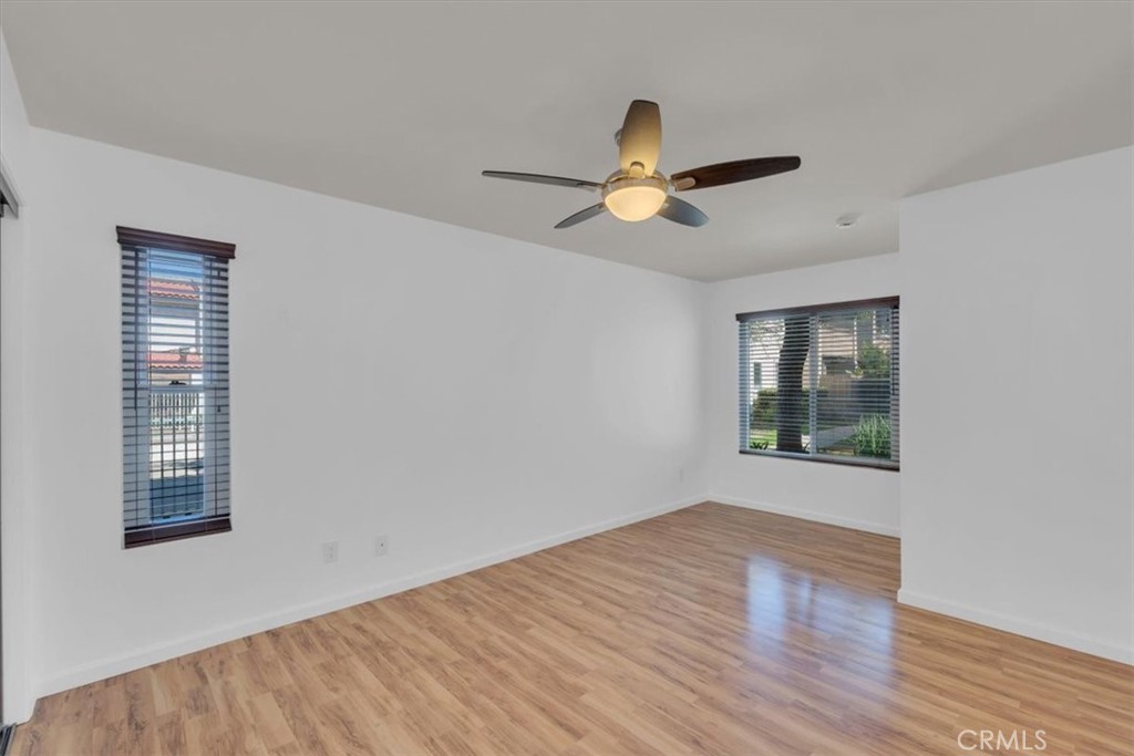 2521 West Sunflower Avenue, Unit H2 Santa Ana, CA 92704 - Photo 16 of 30 a view of empty room with wooden floor and fan