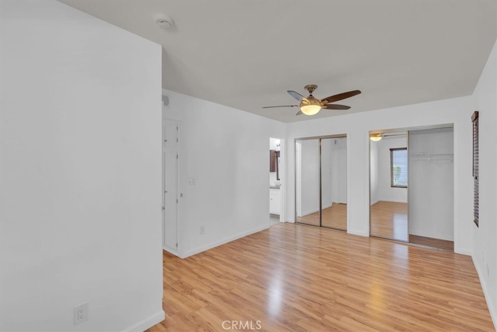 2521 West Sunflower Avenue, Unit H2 Santa Ana, CA 92704 - Photo 17 of 30 a view of an empty room with wooden floor