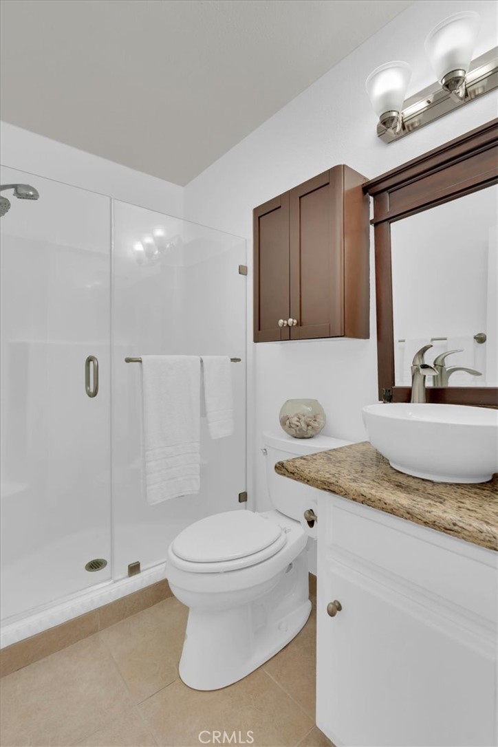 2521 West Sunflower Avenue, Unit H2 Santa Ana, CA 92704 - Photo 19 of 30 a bathroom with a granite countertop sink toilet and shower