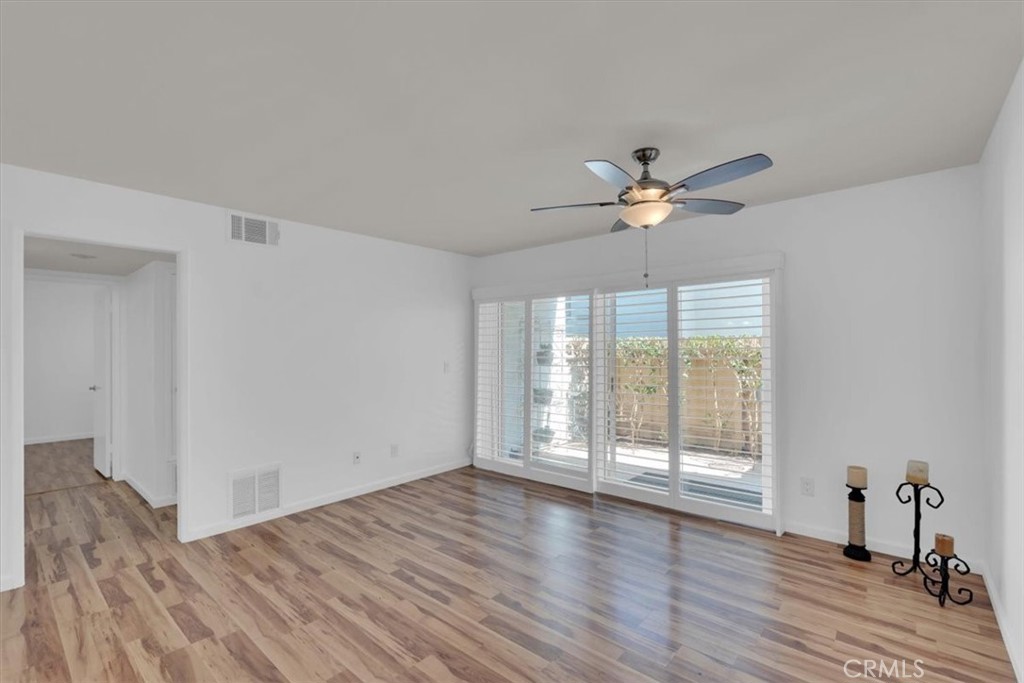 2521 West Sunflower Avenue, Unit H2 Santa Ana, CA 92704 - Photo 3 of 30 a view of an empty room with wooden floor and a ceiling fan