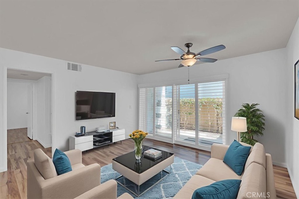 2521 West Sunflower Avenue, Unit H2 Santa Ana, CA 92704 - Photo 4 of 30 a living room with furniture a flat screen tv and a large window