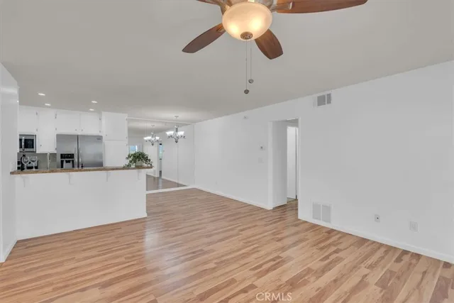 a view of kitchen with microwave and wooden floor