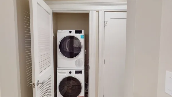 a close view of a utility room with dryer and washer
