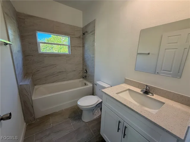 a bathroom with a sink a toilet and bathtub