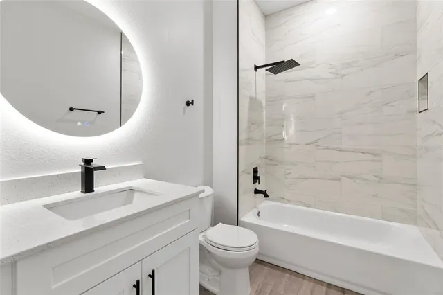 a bathroom with a sink a toilet and a mirror