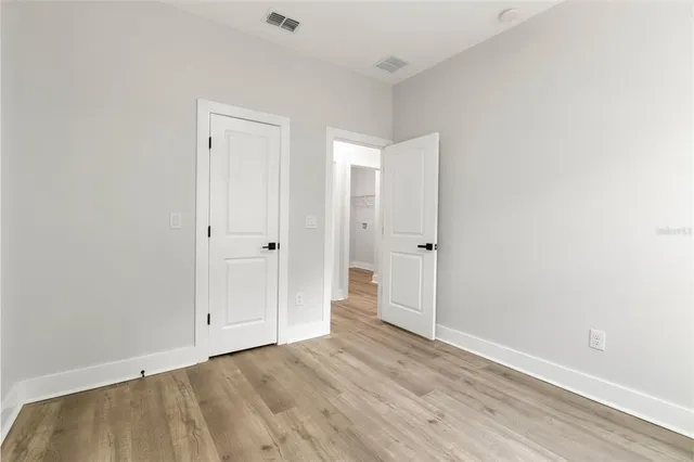 an empty room with wooden floor