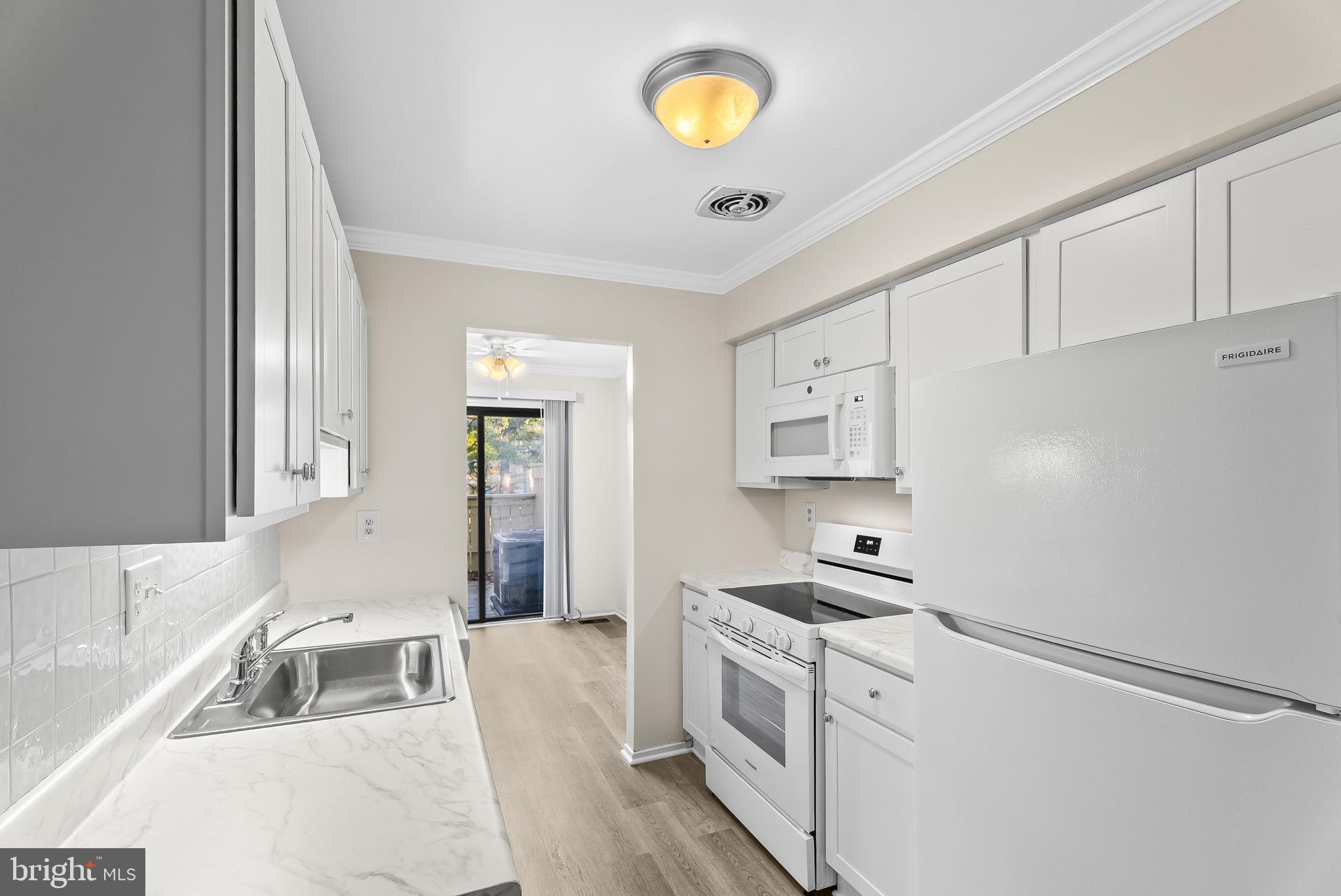 9413 Penshurst Court Gaithersburg, MD 20886 - Photo 16 of 32 a kitchen with stainless steel appliances granite countertop a sink and cabinets