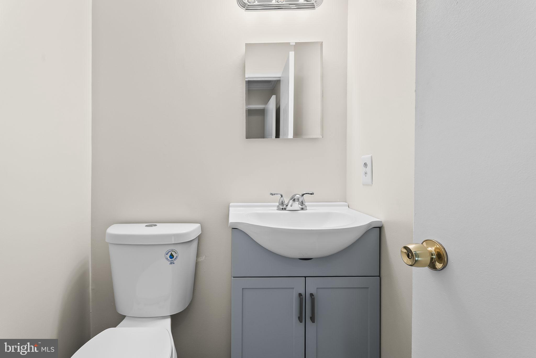 9413 Penshurst Court Gaithersburg, MD 20886 - Photo 17 of 32 a bathroom with a sink a toilet and mirror